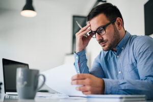 portrait stressed out worried troublesome overworked businessman entrepreneur looking documents report modern bright office working pressure tight deadline portrait stressed out worried troublesome overworked businessman entrepreneur looking documents report modern bright office working pressure tight deadline
