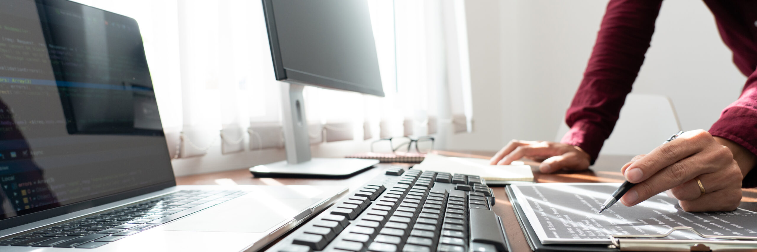man using laptop table scaled man using laptop table scaled