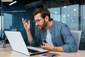 dissatisfied angry businessman looking laptop screen man casual shirt working inside dissatisfied angry businessman looking laptop screen man casual shirt working inside